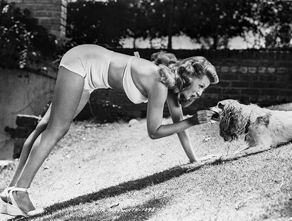 Posterazzi Rita Hayworth wearing a Swimming Suit Feeding a Dog Photo Poster Print, (10 x 8)